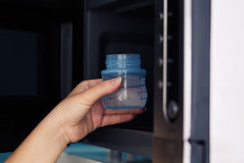 Why the microwave is strongly discouraged for heating breast milk